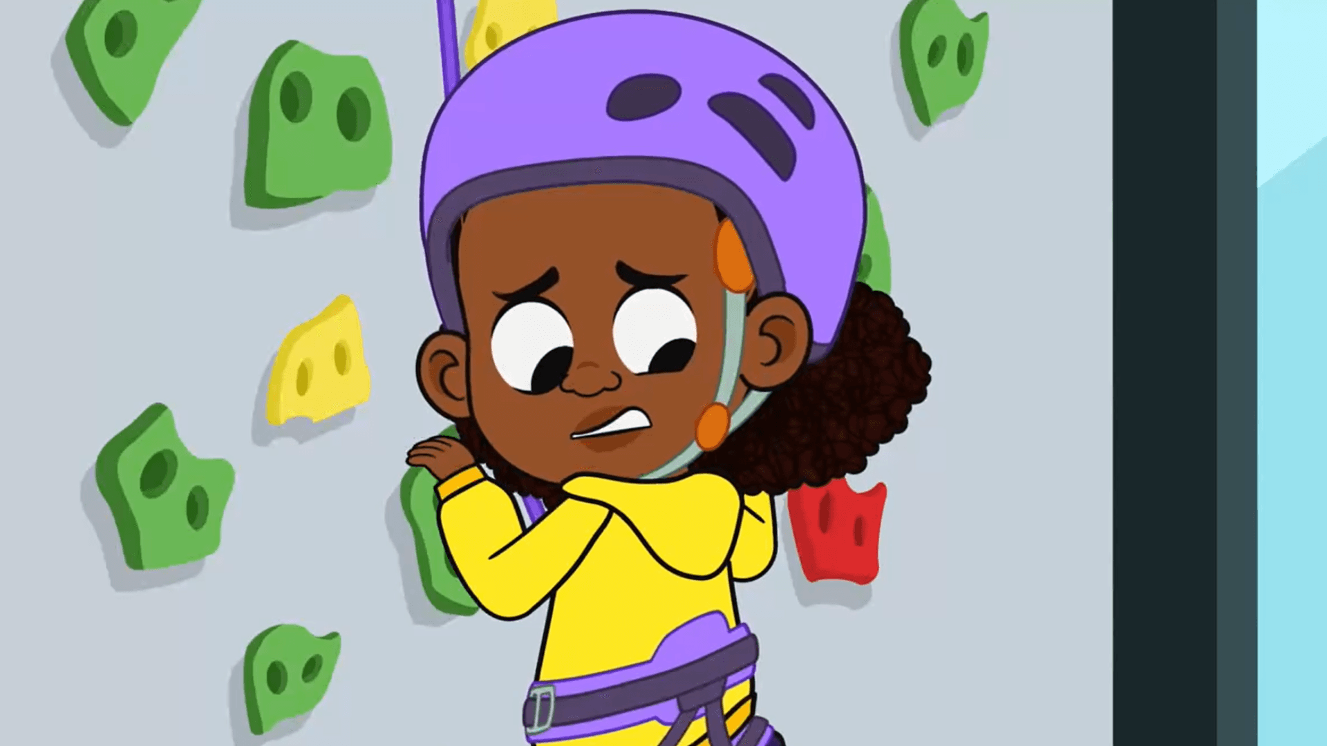 Lyla climbs a rock-climbing wall for the first time.